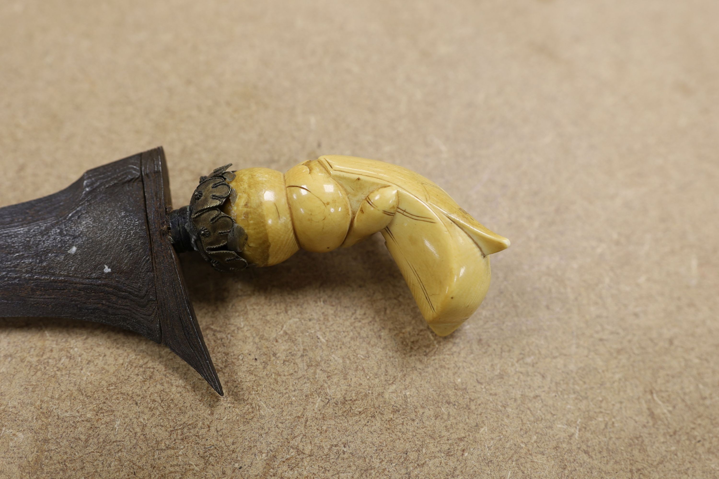 A 19th century ivory handled Kris, 40 cms long.
